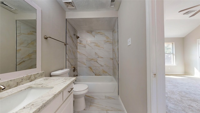 full bathroom featuring tiled shower / bath, vanity, a textured ceiling, and toilet