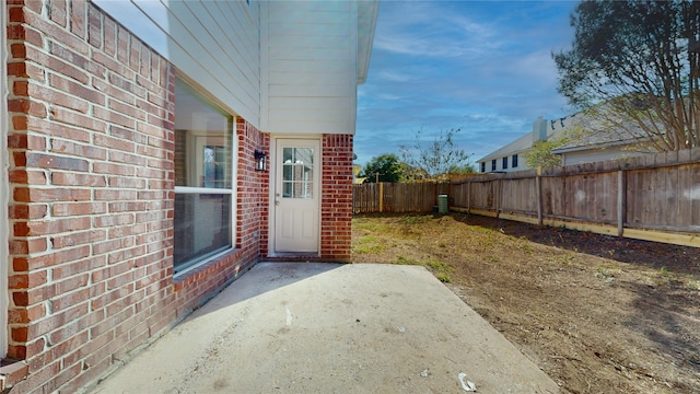 view of exterior entry featuring a patio