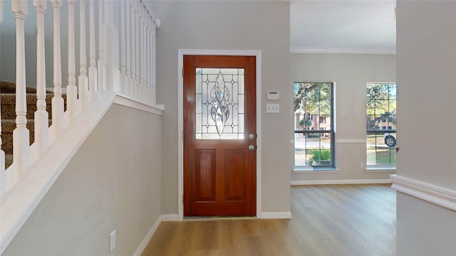 entrance foyer with crown molding and light wood-type flooring