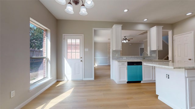 kitchen with sink, dishwasher, light wood-type flooring, kitchen peninsula, and white cabinets