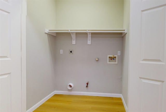 clothes washing area with hookup for a washing machine, electric dryer hookup, gas dryer hookup, and hardwood / wood-style floors