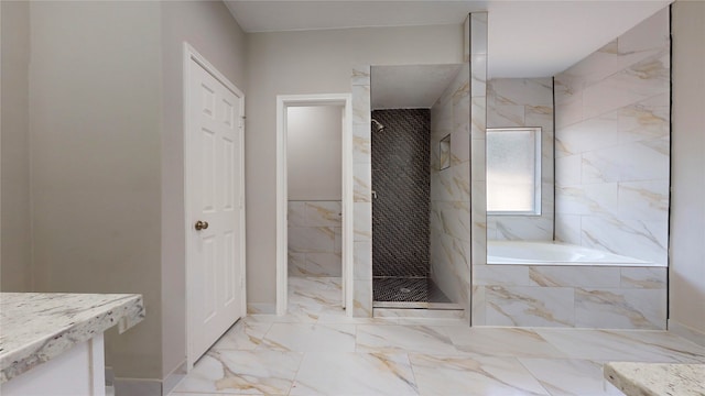 bathroom with vanity and independent shower and bath