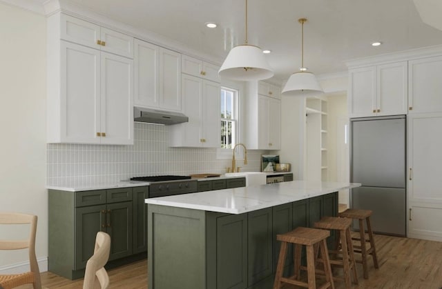 kitchen featuring a kitchen island, hanging light fixtures, white cabinetry, extractor fan, and stainless steel refrigerator