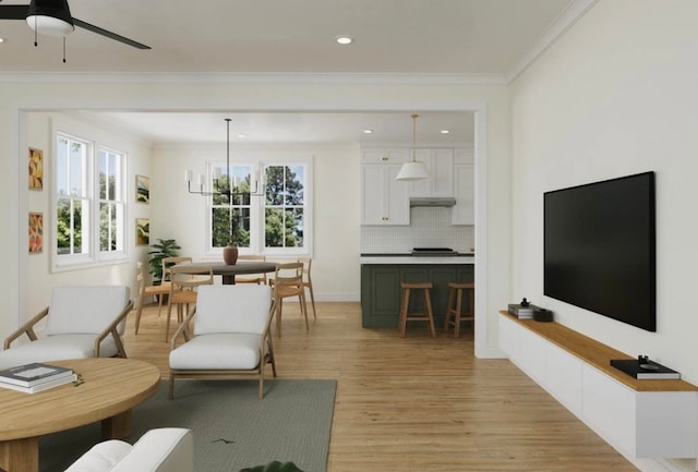 living room with crown molding, light wood-type flooring, and ceiling fan with notable chandelier