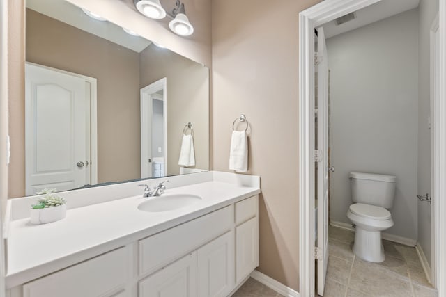 bathroom with vanity, toilet, and tile patterned flooring