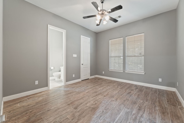 empty room featuring wood-type flooring and ceiling fan