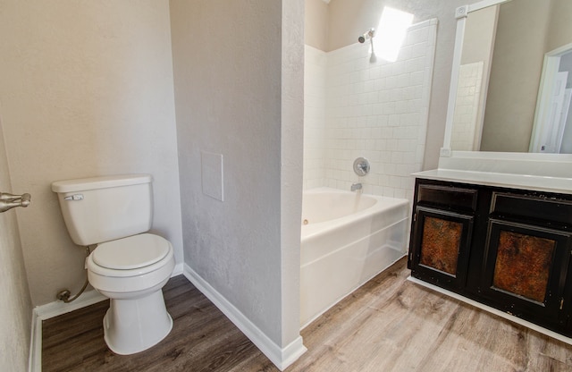 full bathroom featuring toilet, hardwood / wood-style floors, vanity, and shower / bath combination