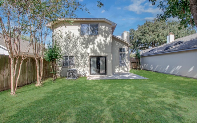 back of house with a patio, cooling unit, and a yard