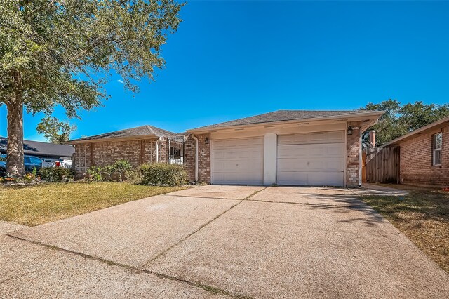 ranch-style house featuring a front yard and a garage