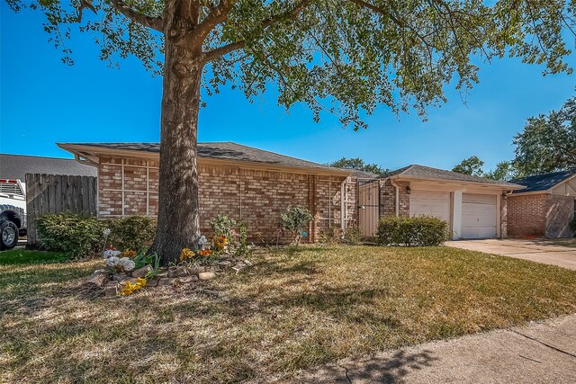 single story home with a garage and a front lawn