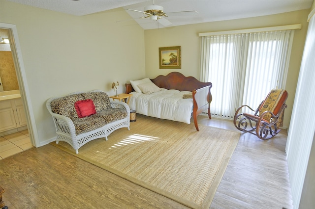 bedroom with light wood-type flooring, ensuite bathroom, and ceiling fan