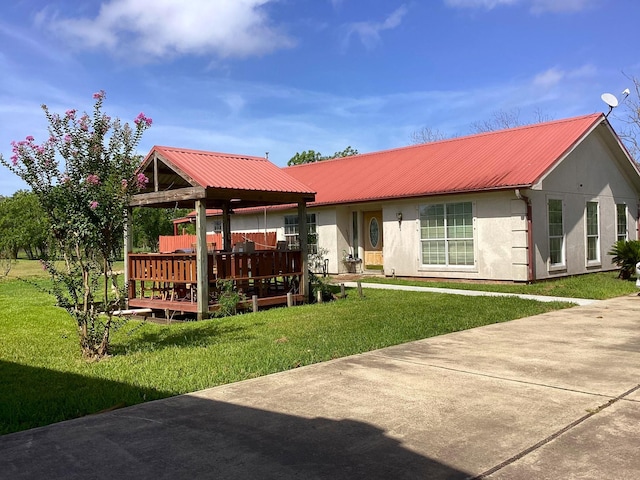 back of house featuring a wooden deck and a yard