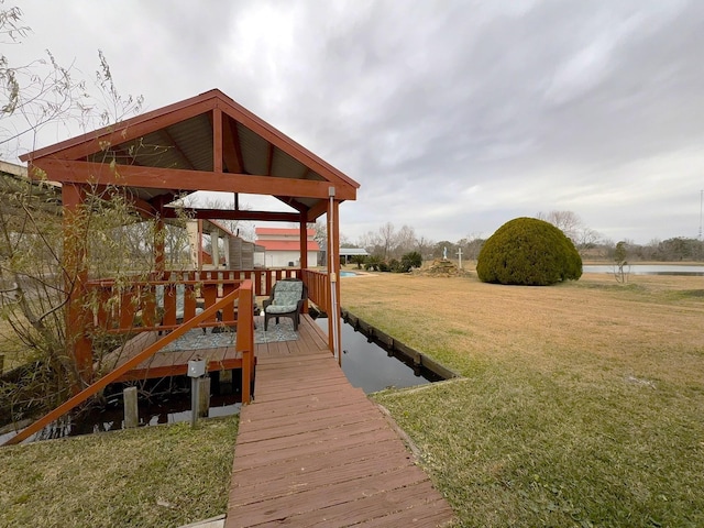 dock area with a water view and a yard