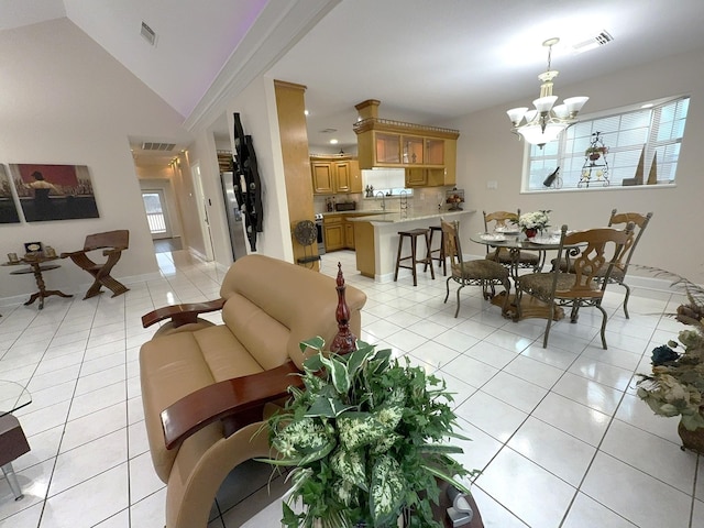 dining room with plenty of natural light, lofted ceiling, a chandelier, and light tile patterned floors