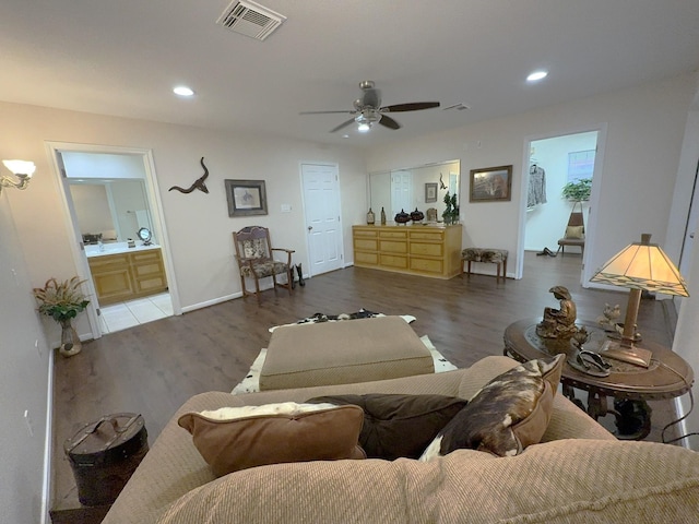 living room featuring dark hardwood / wood-style flooring and ceiling fan