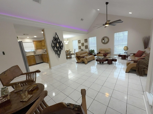 tiled living room featuring high vaulted ceiling and ceiling fan with notable chandelier