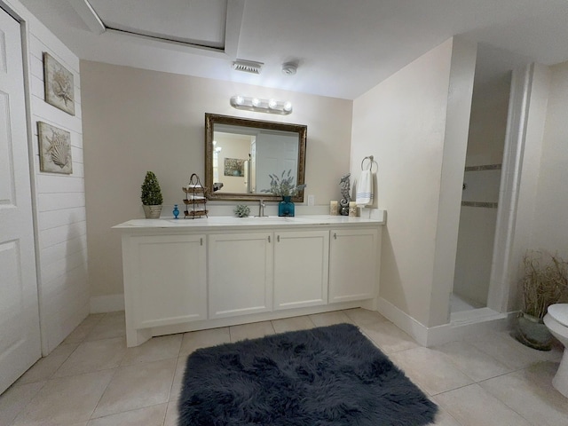 bathroom with vanity, tile patterned floors, toilet, and a shower