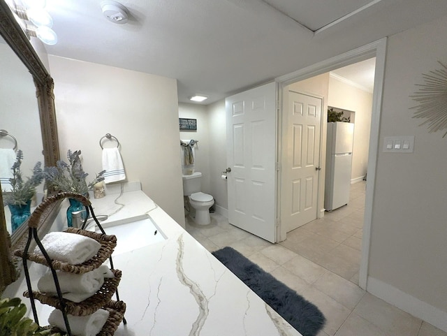 bathroom featuring vanity, toilet, and tile patterned flooring