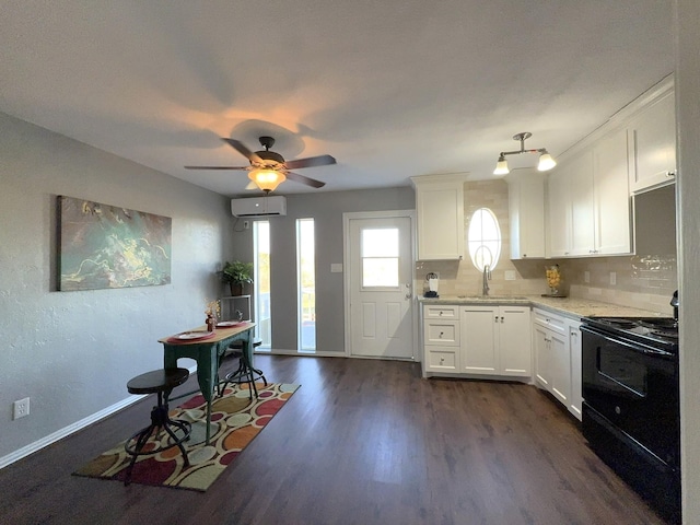 kitchen with sink, electric range, dark hardwood / wood-style floors, white cabinets, and backsplash