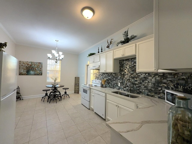 kitchen with crown molding, sink, white appliances, and decorative backsplash