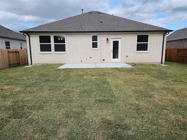 back of property featuring a lawn and a patio area