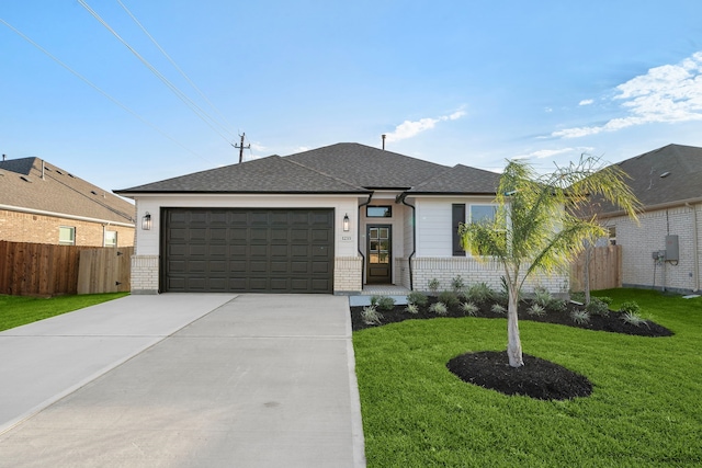 single story home with a front yard and a garage