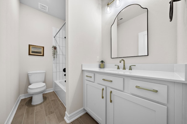 full bathroom featuring toilet, hardwood / wood-style floors, vanity, and tiled shower / bath