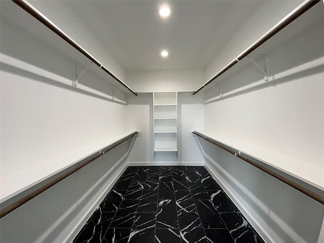 spacious closet featuring marble finish floor