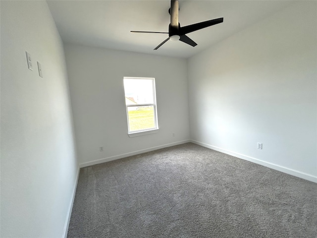 carpeted empty room featuring a ceiling fan and baseboards