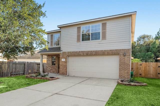 view of property featuring a front yard and a garage