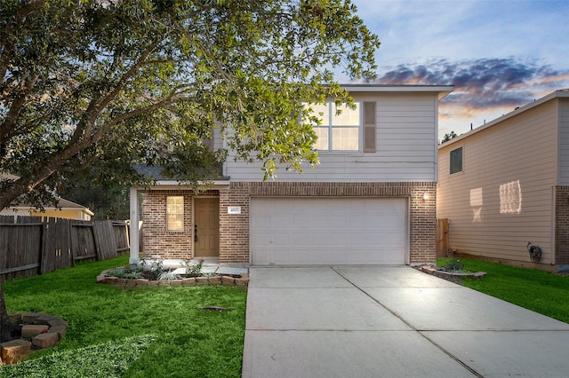 view of front of home with a lawn and a garage