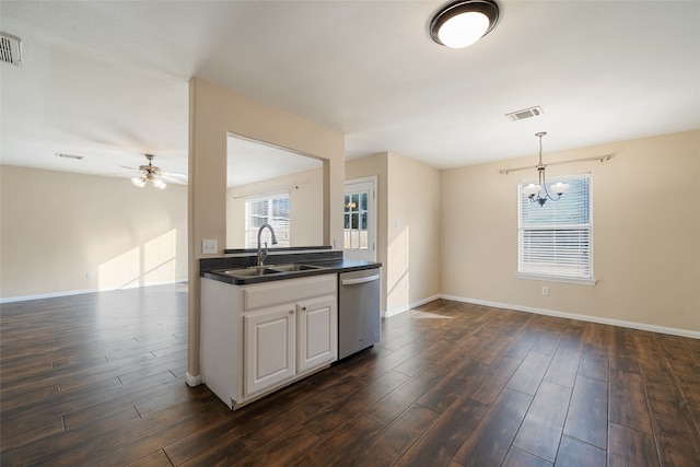 kitchen featuring pendant lighting, sink, stainless steel dishwasher, and dark hardwood / wood-style flooring