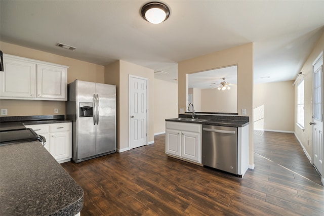 kitchen with stainless steel appliances, sink, dark hardwood / wood-style floors, and white cabinets