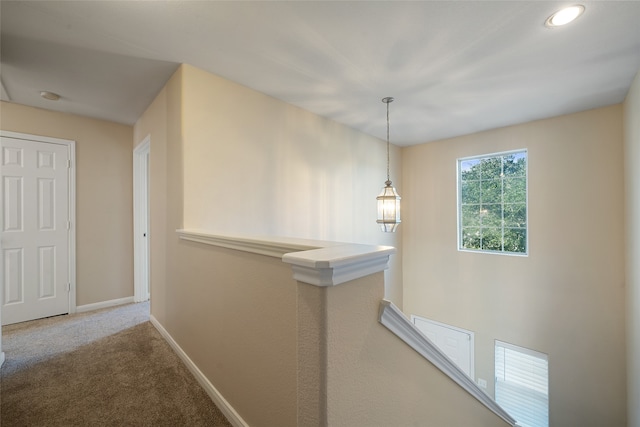 hallway with carpet floors