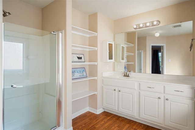 bathroom with vanity, hardwood / wood-style flooring, and walk in shower