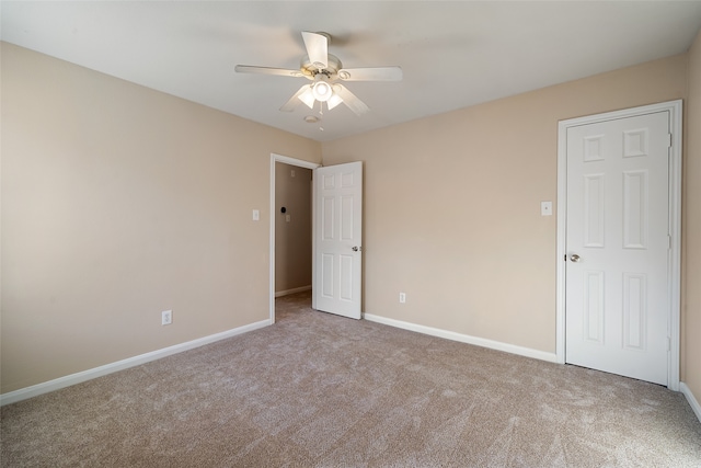 unfurnished room featuring light colored carpet and ceiling fan