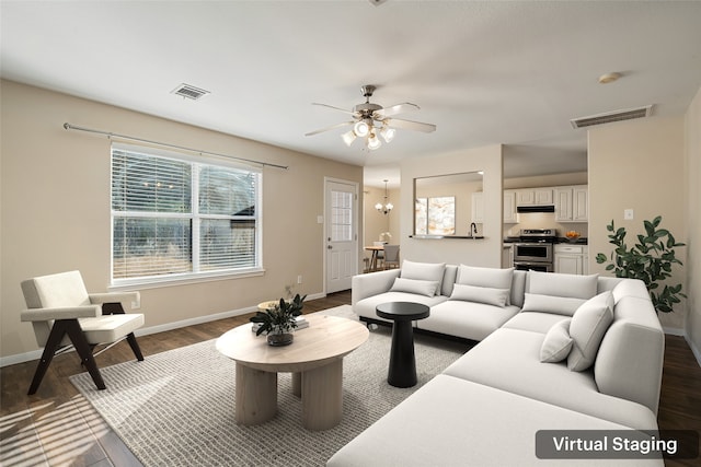 living room featuring sink, ceiling fan with notable chandelier, and dark hardwood / wood-style flooring