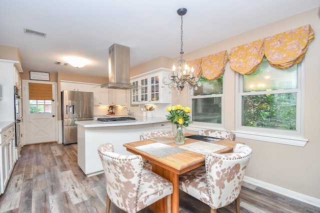 dining room with hardwood / wood-style floors, a wealth of natural light, and a chandelier