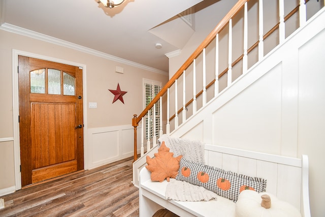 entrance foyer with hardwood / wood-style flooring and ornamental molding