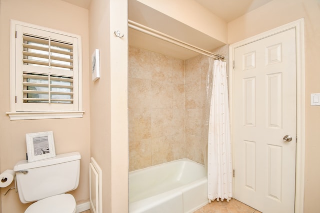 bathroom with tile patterned floors, shower / bath combo, and toilet