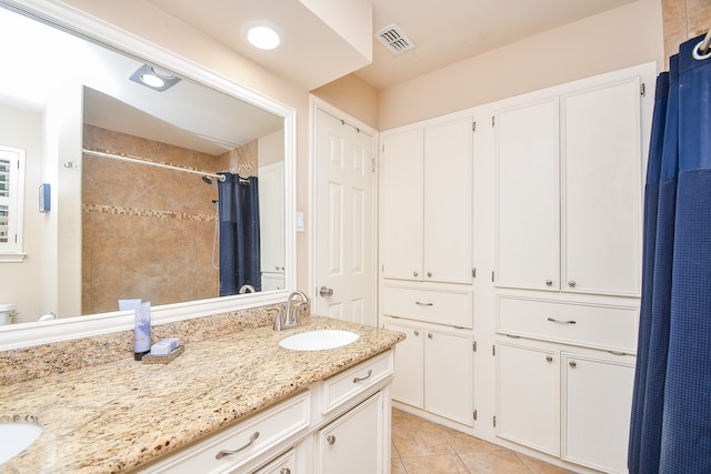 bathroom featuring vanity, walk in shower, and tile patterned flooring