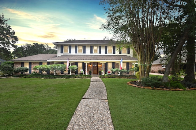 view of front facade featuring a lawn and covered porch