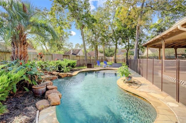 view of swimming pool featuring pool water feature and a patio