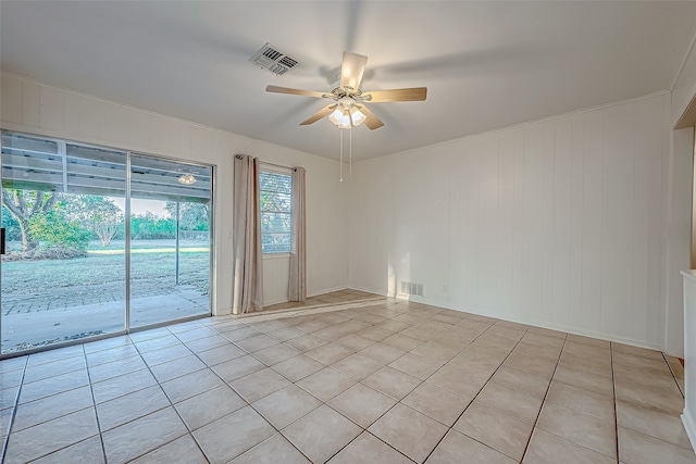 tiled empty room featuring ceiling fan