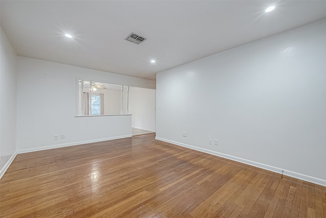 spare room with light hardwood / wood-style floors and ceiling fan