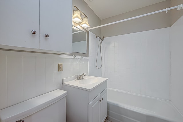 full bathroom with toilet, tiled shower / bath combo, vanity, and tile walls