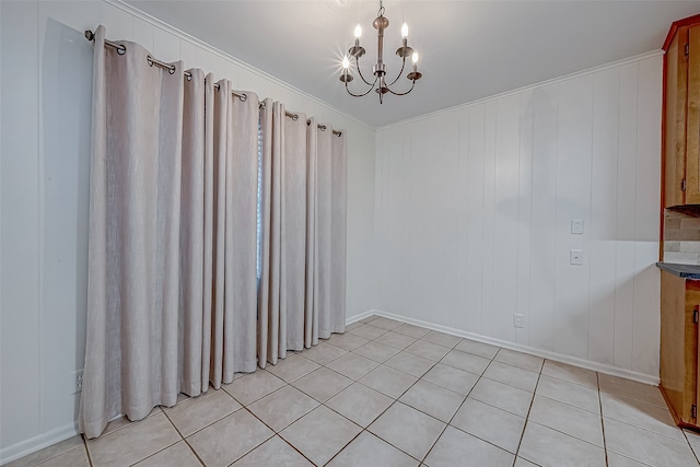 empty room with ornamental molding, a chandelier, light tile patterned flooring, and wood walls