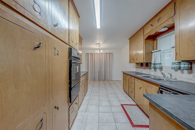 kitchen with tasteful backsplash, sink, decorative light fixtures, light tile patterned floors, and a chandelier