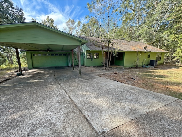 single story home with a front yard, central AC, a garage, and a carport