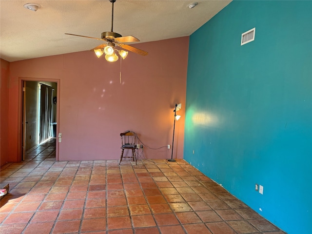 unfurnished room with ceiling fan and vaulted ceiling